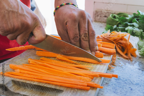 man's hands, cut carrot julienne style