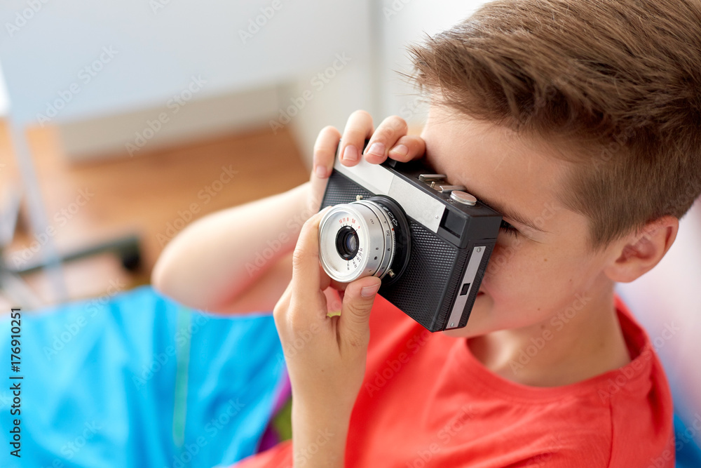 close up of boy photographing by film camera close up of boy photographing by film camera