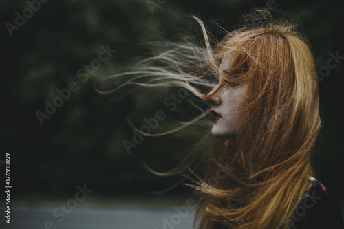 Young woman with hair blowing in the wind 