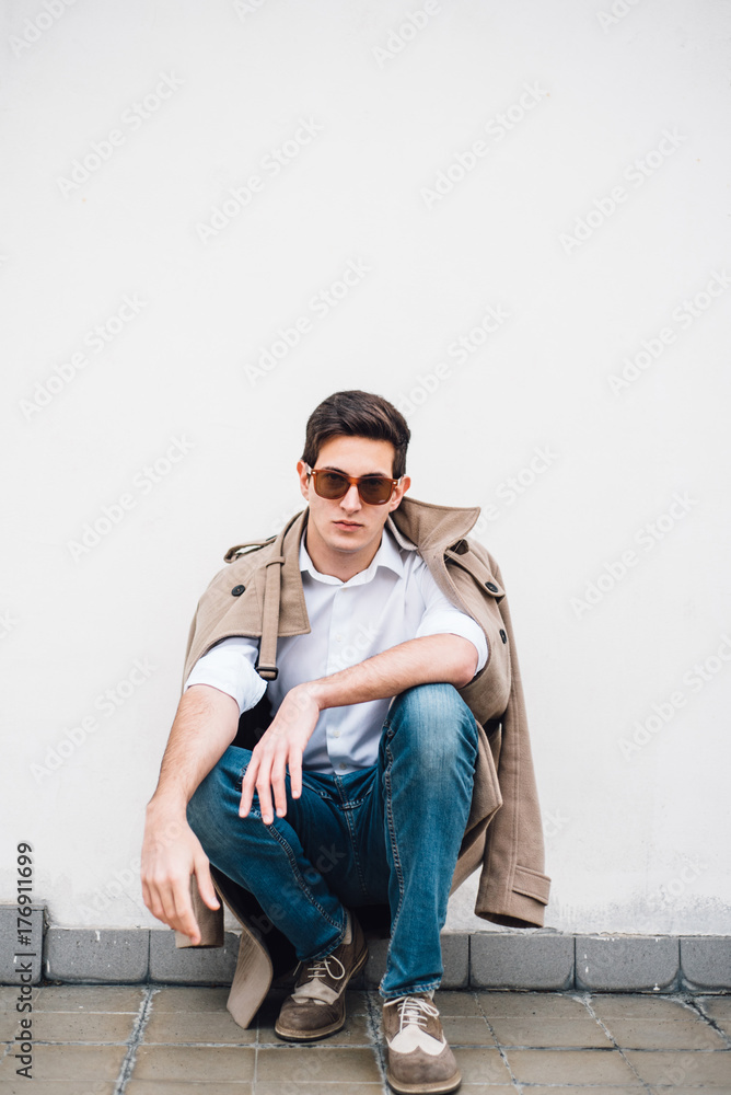 Portrait of stylish man against the wall Portrait of stylish man against the wall