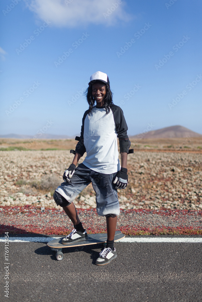 Female Afro Skater Doing Downhill with Longboard Stock Photo | Adobe Stock