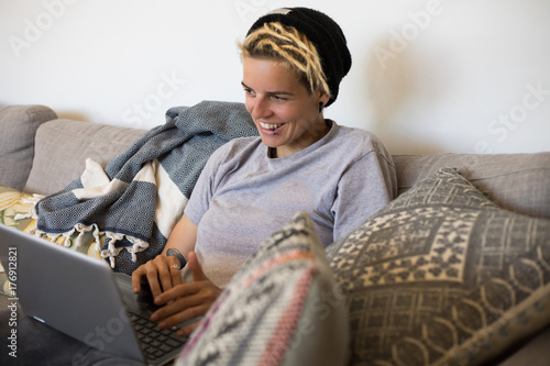 Girl working on laptop on Lounge at home