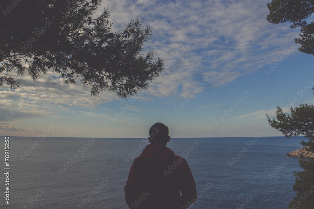 Young man standing by the sea, Dubrovnik Young man standing by the sea, Dubrovnik