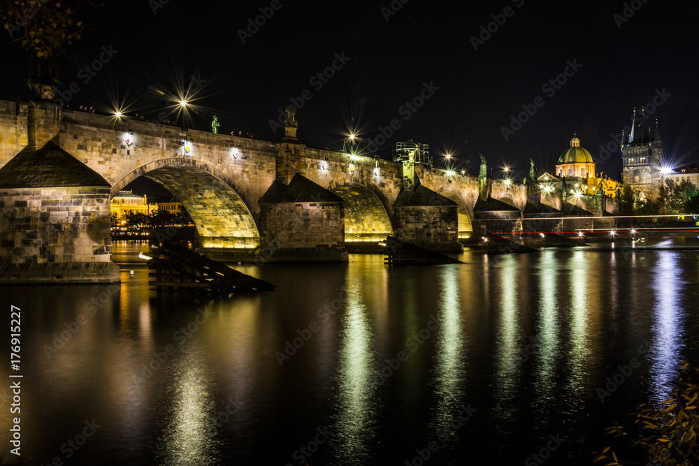 Karl´s bridge in the capital city of Czech republic, Prague. Night view on lights reflection in river Vltava.