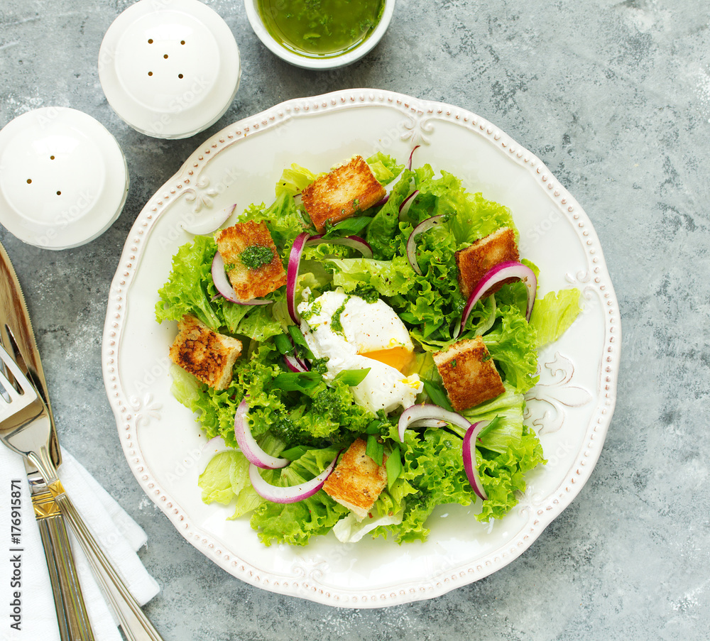 Spring salad with poached egg and crispy croutons. View from above. Spring salad with poached egg and crispy croutons. View from above.