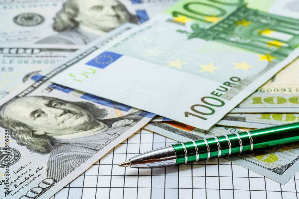 Euro and dollars. Credit card and ballpoint pen next to banknotes. The main currencies of the world. Money. Background with money. Euro and dollars. Credit card and ballpoint pen next to banknotes. The main currencies of the world. Money. Background with money.