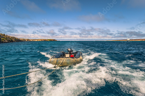 Galapagos Islands - August 24, 2017: Boat riding on the coast of Santa Cruz island, Galapagos Islands, Ecuador photo