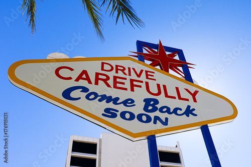 The Welcome to Fabulous Las Vegas sign on bright sunny day in Las Vegas.Welcome to Never Sleep city Las Vegas, Nevada Sign with the heart of Las Vegas scene in the background. photo