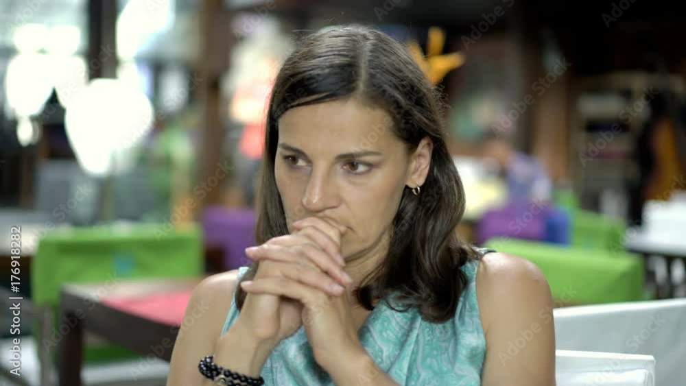 Attractive woman looks worried while thinking about something, steadycam shot
Attractive woman looks worried while thinking about something, steadycam shot