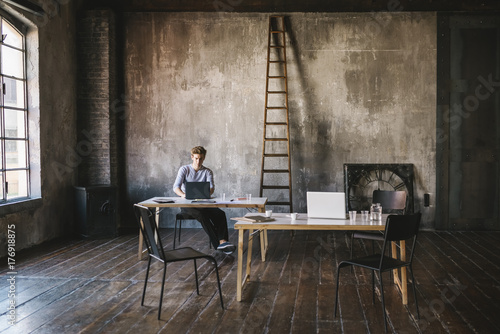 Businessman working in a contemporary loft office photo