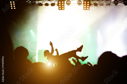Sticker Stage diving. Crowd surfing during a musical performance