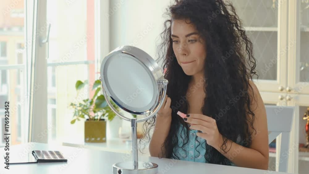 Woman makes up in front of the mirror Woman makes up in front of the mirror