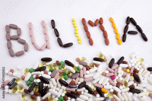 Conceptual Hand writing text caption inspiration Medical care Health concept written with pills drugs capsule word bulimia On white isolated background with copy space photo