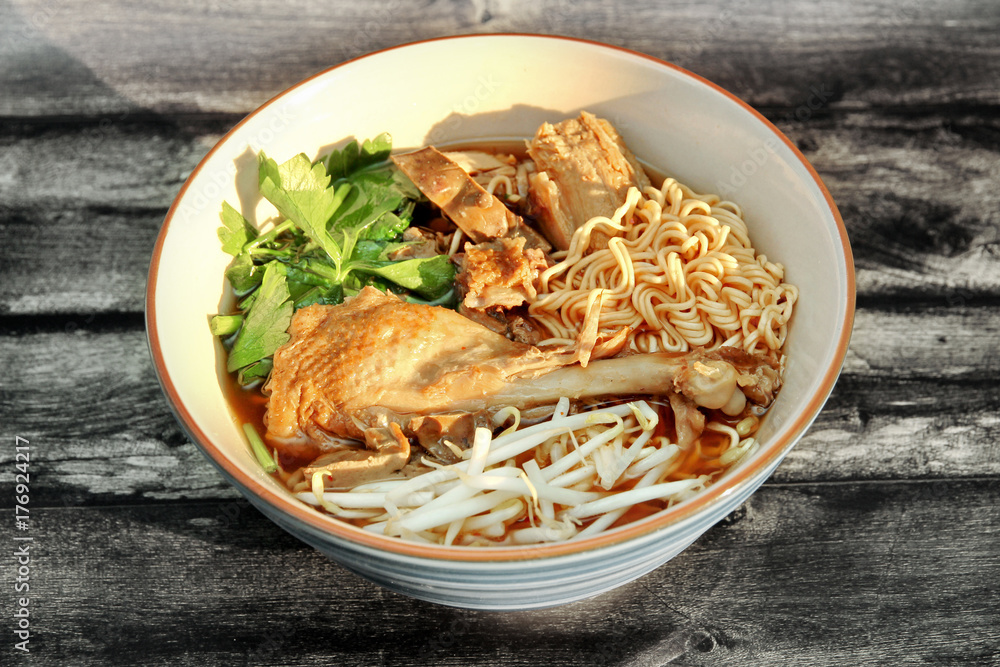 Steam duck and instant noodles in brown sauce.