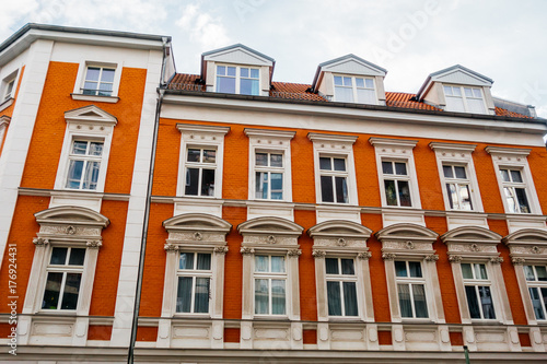 red facaded brick building with white stucco © Robert Herhold