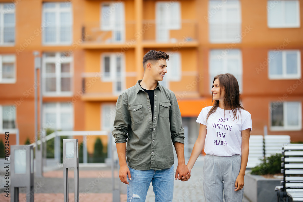 Trendy young couple of lovers walking in the street Trendy young couple of lovers walking in the street