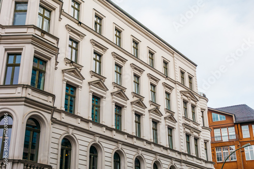 white apartment house next to an red one