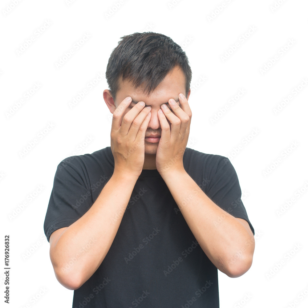 young man closes his eyes with his hands isolated on white background with clipping path.Emotions and people have a stress disease concept young man closes his eyes with his hands isolated on white background with clipping path.Emotions and people have a stress disease concept