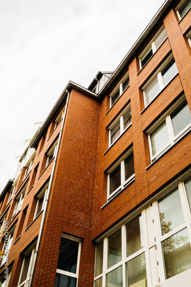 Naklejka premium low angle view of brick apartment building