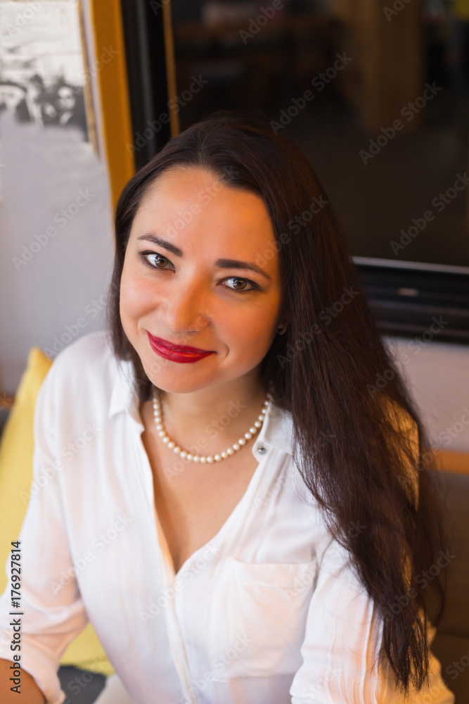 Portrait of a business woman wearing white shirt and pearl neckl
