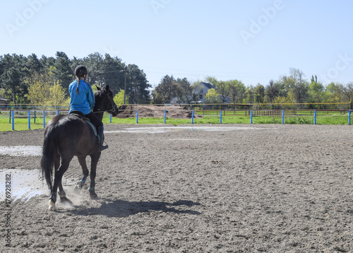 Equestrian sports with teenagers. Horse Club. A girl is riding a