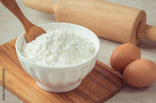 Flour in bowl with eggs and rolling pin