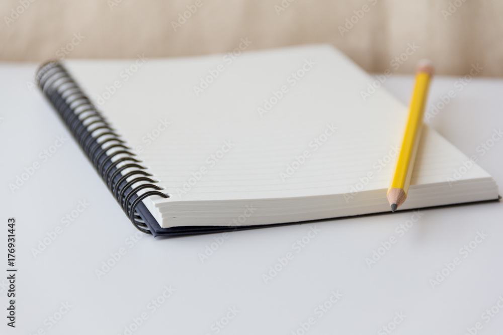 notebook paper and pencil closeup on white background notebook paper and pencil closeup on white background
