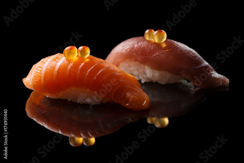 Closeup composition of fresh salmon sashimi sushi with caviar on a dark background