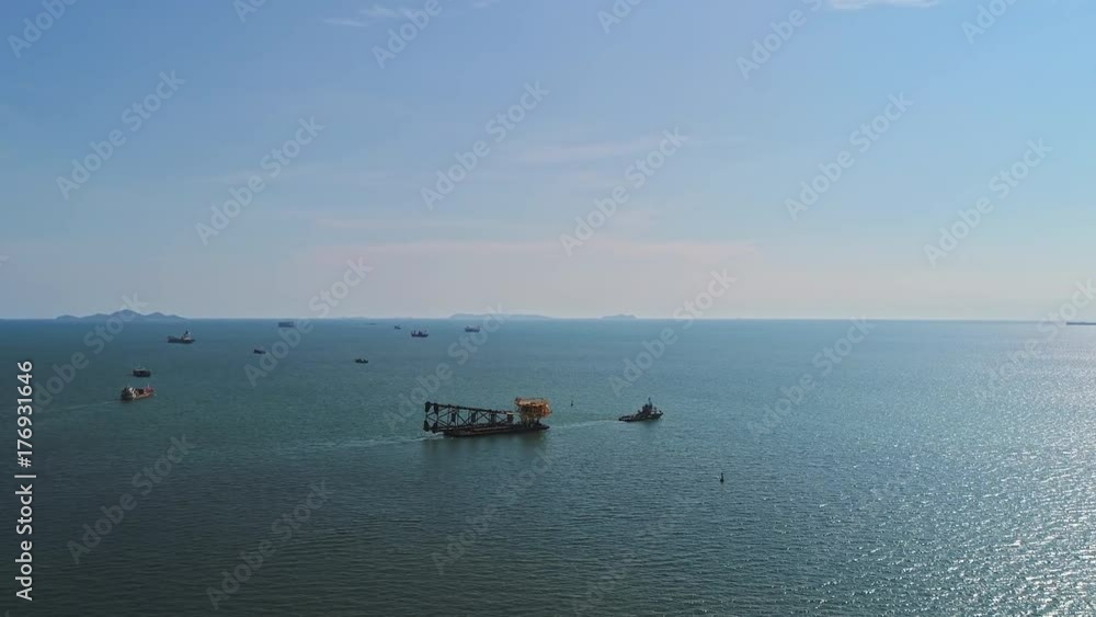 Aerial view of moving oil rig by tug boat. Aerial view of moving oil rig by tug boat.