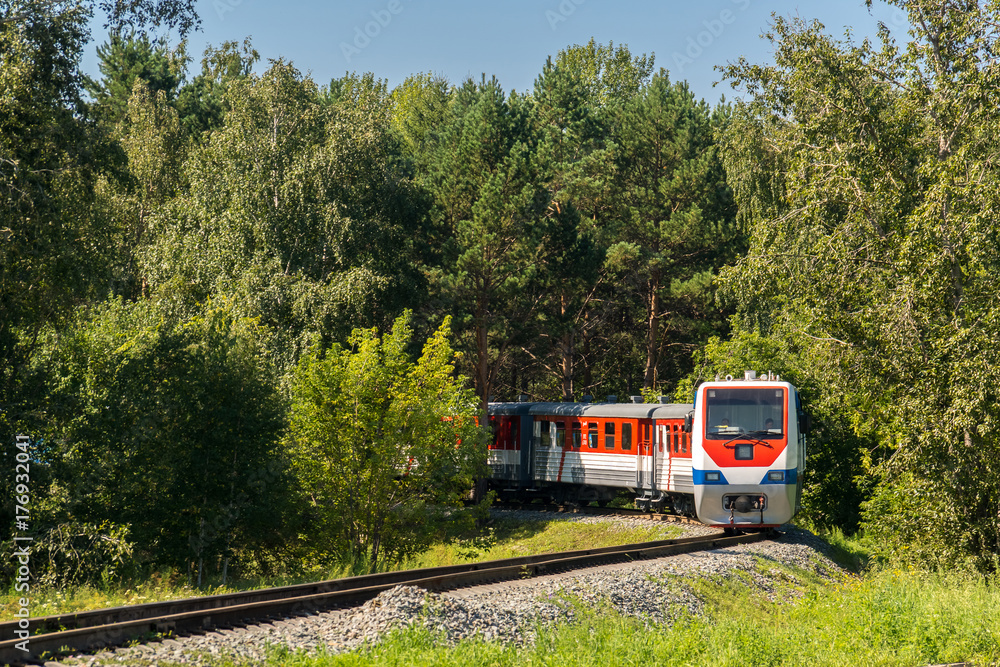 Naklejka premium The train travels along the Children's Railway on the Konny island in the Irkutsk city