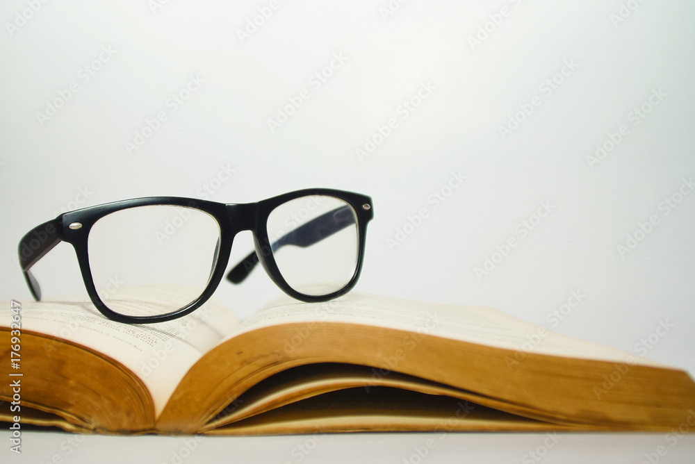 Glasses On Old Book Over White Background Glasses On Old Book Over White Background