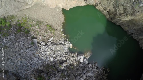 Tuimsky Proval 01. Deep technogenic collapse pit (failure) inside a mountain on the site of excavation of polymetallic ores. Static shot. Tuim, Shira district, Republic of Khakassia, Russia. photo