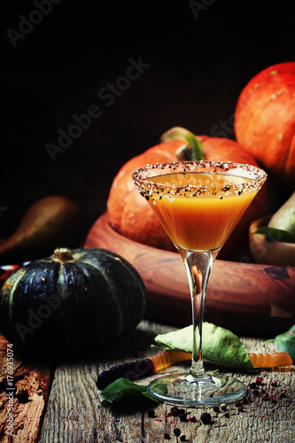 Halloween orange cocktail on a dark festive background, selective focus