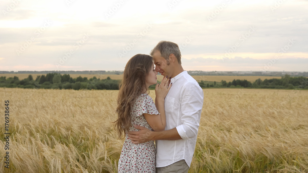 Romantic date on a wheat field, love couple hugs Romantic date on a wheat field, love couple hugs