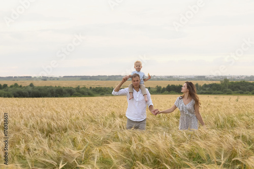 Happy childhood, family together on wheat field