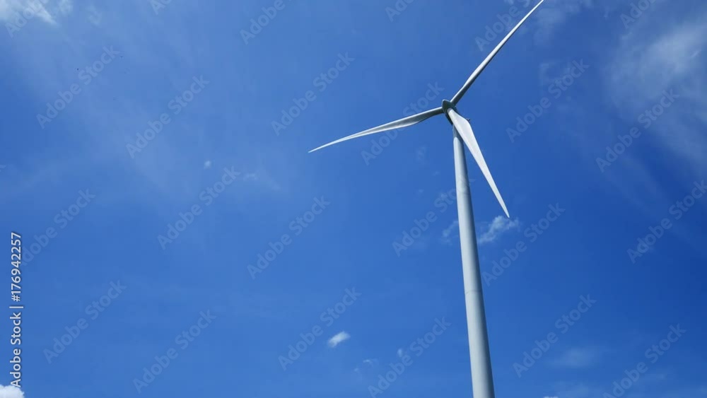 A wind farm and wind turbines for electricity generation on sunny day with blue sky in Thailand
A wind farm and wind turbines for electricity generation on sunny day with blue sky in Thailand