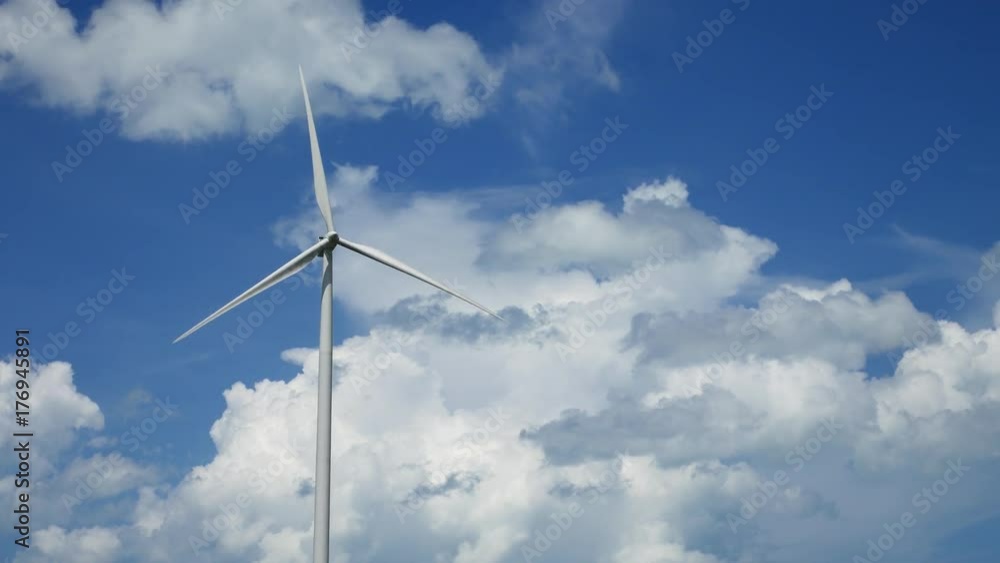 A wind farm and wind turbines for electricity generation on sunny day with blue sky in Thailand
A wind farm and wind turbines for electricity generation on sunny day with blue sky in Thailand