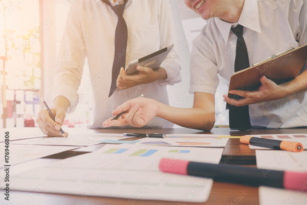 Business meeting concept, two people planning on business static data report on desk with vintage tone. Business meeting concept, two people planning on business static data report on desk with vintage tone.