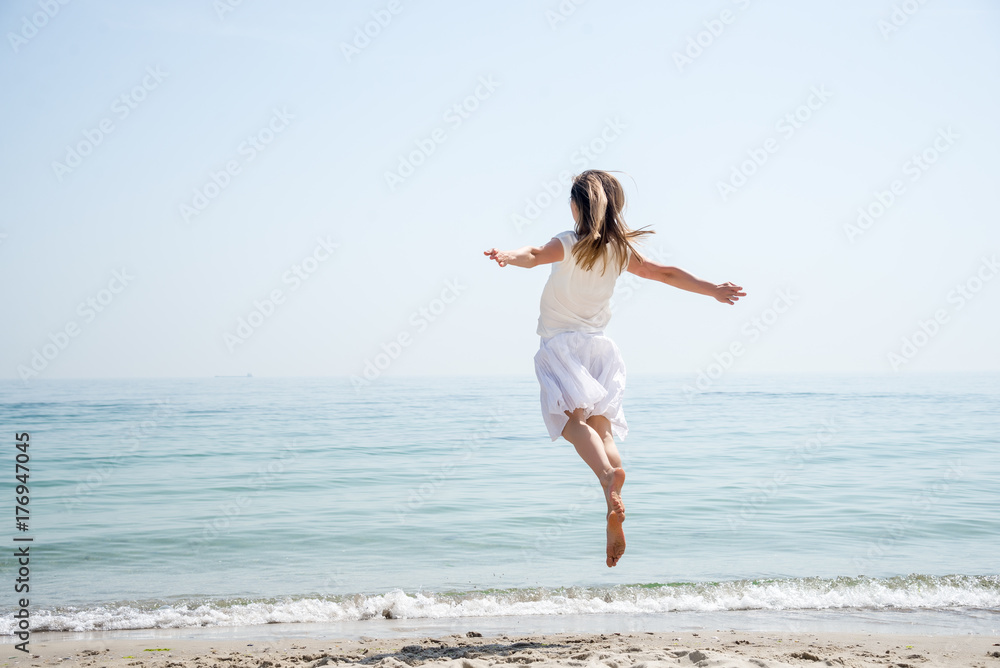 Happy beautiful young girl jumping Happy beautiful young girl jumping