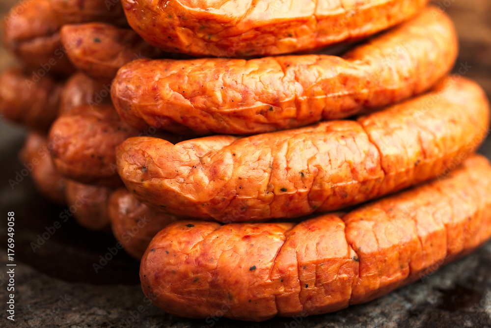 Stack of deliciously smoked handmade Swedish Isterband sausages with natural casing. Stack of deliciously smoked handmade Swedish Isterband sausages with natural casing.