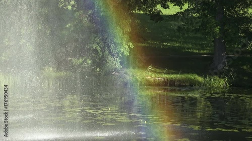 4K video footage of colorful rainbow on the pond close up view