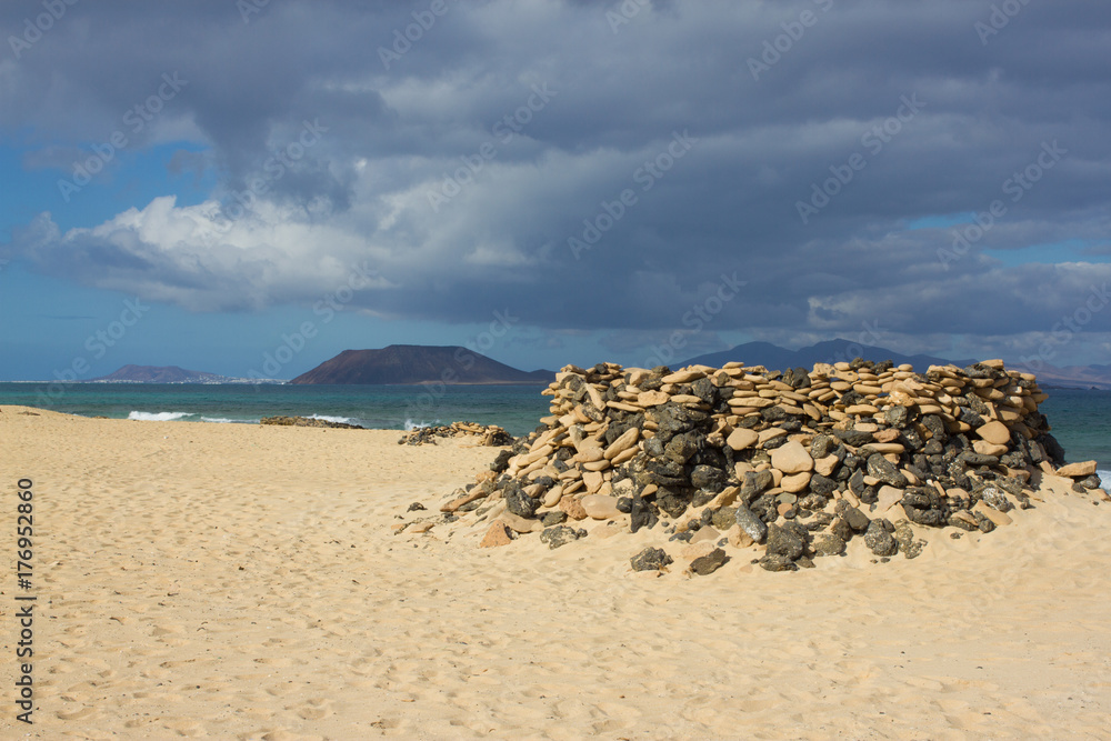 Panoramic ocean view. Volcano, black rocks. Sand macro. Sea background. Horizon.
