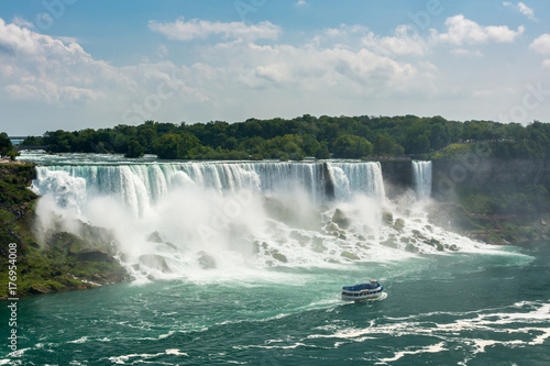 Tourist boat under the American Falls  which are part of Niagara Falls