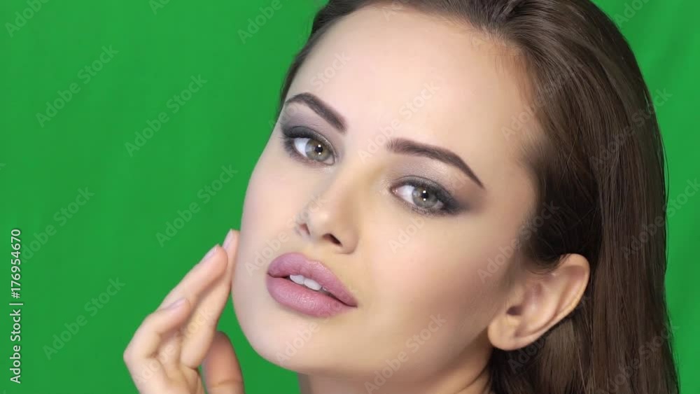 Beautiful woman pampering skin of face Beautiful woman pampering skin of face