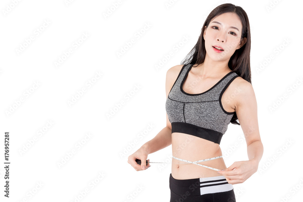 Woman slim measuring her waist using a tape measure isolated on white background Woman slim measuring her waist using a tape measure isolated on white background