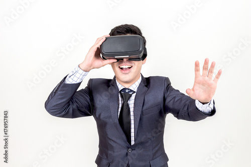 Young man enjoy with virtual reality glasses on white background