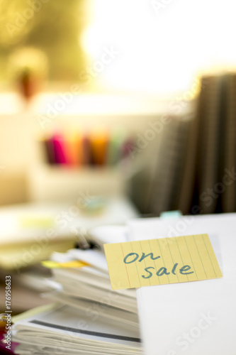 On Sale; Stack of Documents. Working or Studying at messy desk. photo