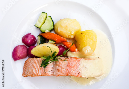 grilled salmon and lemon - french cuisine dish with tomato and salmon