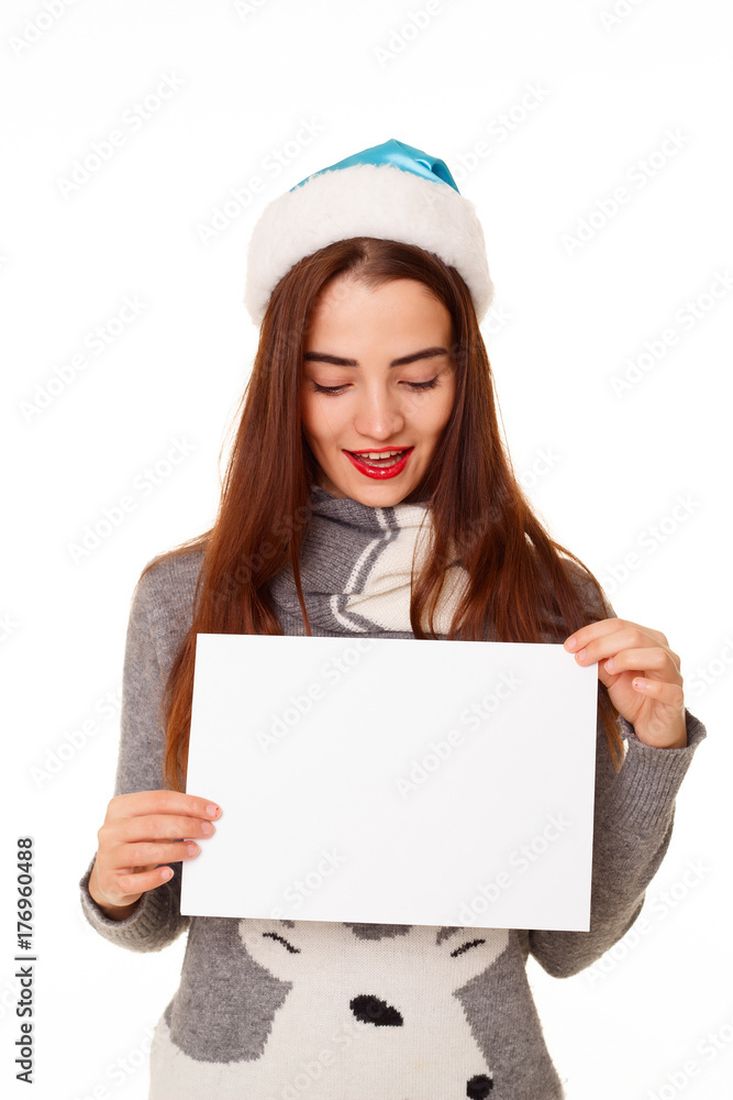 Young happy woman in warm sweater with empty paper over white background Young happy woman in warm sweater with empty paper over white background