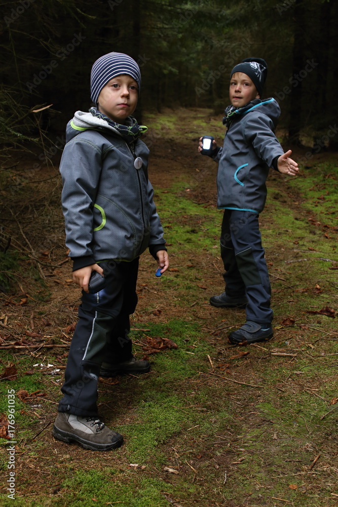 Two boys playing with lanterns in the woods